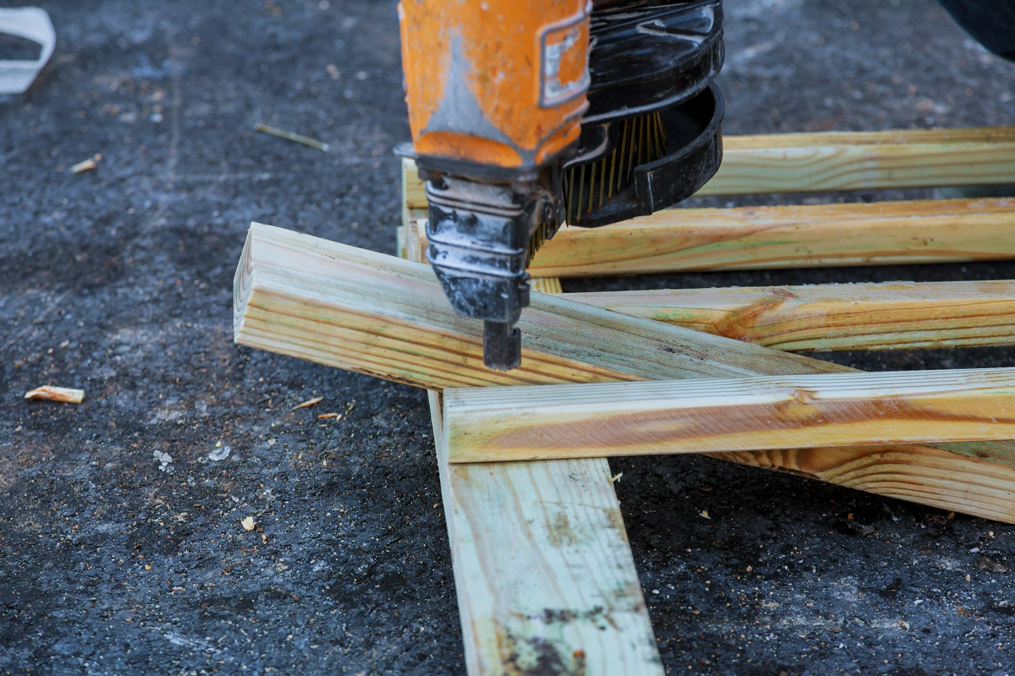 Closeup of a contractor to mark down some dimensions on a wood board
