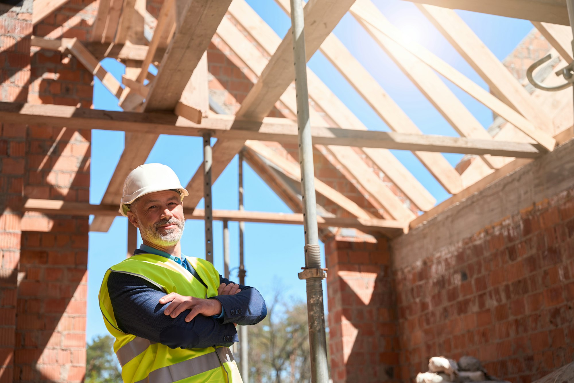 Confident man building constructor standing with folded on chest hands